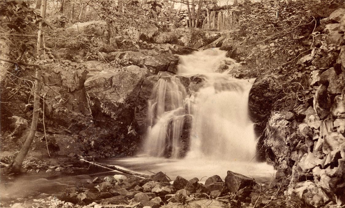 Image of the waterfall at the Waverley Oaks reservation and link to our YouTube channel presentation by Marie Daly
