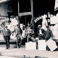 Image of six men in front of the Stearns Brothers shop on Moody Street